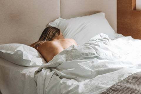 Woman having a relaxing and comforting nap after taking CBD products for sleep.